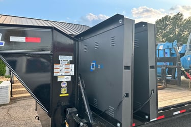 Two black outdoor LED screen panels loaded on a flatbed trailer for industrial transport and staging.