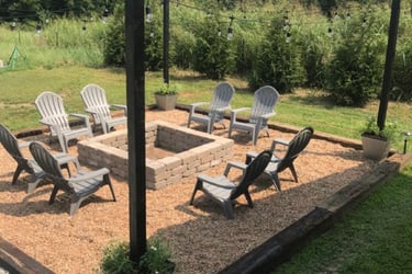 a fire pit with chairs and chairs around it