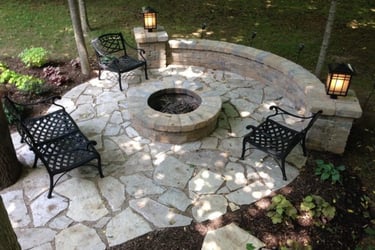 a outdoor area with chairs and a fire pit