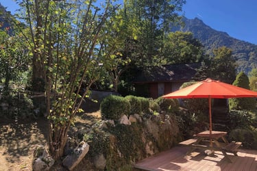 a picnic table with a red umbrella