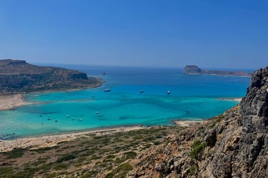 a view of a beach with boats and a blue sky