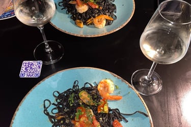 a plate of pasta with shrimp and pasta
