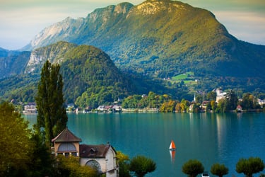 a boat on a lake with mountains in the background