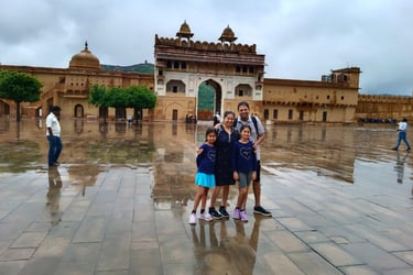 a family posing for a picture in front of a building