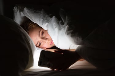 Woman awake at night feeling anxious and troubled while seeking answers and guidance on the phone