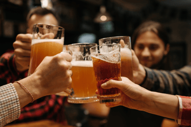 a group of people toasting with beer