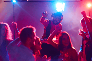 a man in a red jacket is dancing at a party