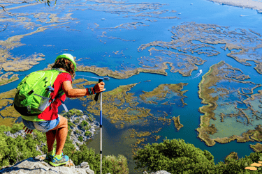 a man with a backpack on a hill looking through Iztuzu Beach