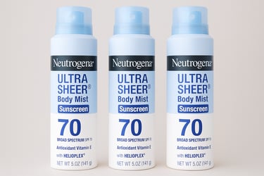 Three bottles of Neutrogena Ultra Sheer Body Mist sunscreen SPF 70 on a neutral background