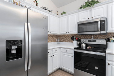 Kitchen with white cabinets and stainless steel appliances