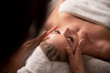 a woman getting a facial massage at a spa