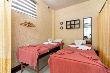 two beds in a room with towels and towels
