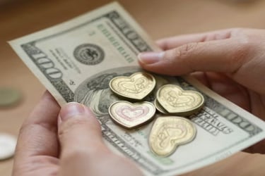 One hundred dollar bill with heart shaped coins