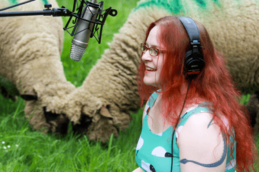 Rachael with her recording equipment out in the sheep field