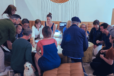 a bootcamp cohort sitting around a table working on an exercise