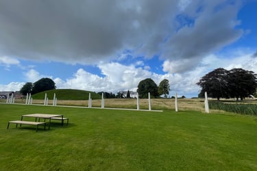 posts that represent an ancient ship surrounding the Burial mound at the centre of jelling, Denmark