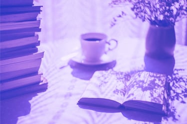 a book and a cup of coffee on a table