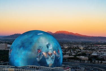 image of a cyborg on the sphere in las vegas, taken from atop the high roller, with mountains 