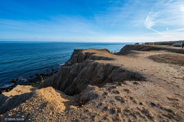 bluffs and dirt overlooking the atlantic ocean with the horizon in background, montauk ny