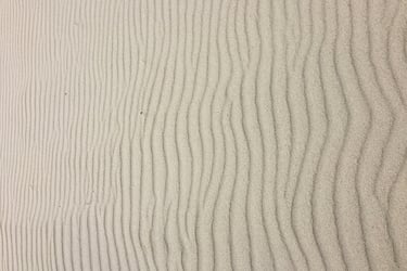 background image - wind waves on a light brown fine sand field