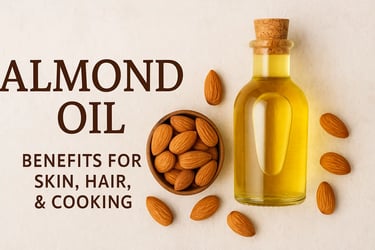 A glass bottle of almond oil with a cork beside a wooden bowl filled with almonds