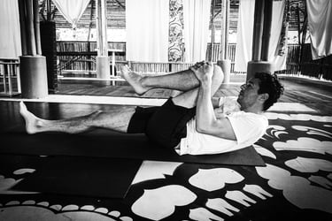 A man practising yoga on a mat