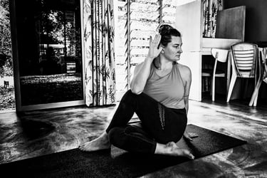 A woman performs a yoga pose - Ardha Matsyendrasana, or Half Lord of the Fishes Pose,