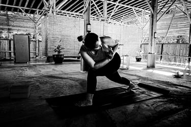 A woman practices a twisting yoga pose