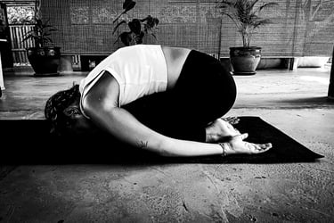 A woman practising yoga - Child Pose