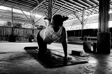 A woman practising a yoga pose on a mat