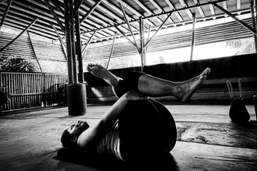 A woman practices a reclining yoga pose