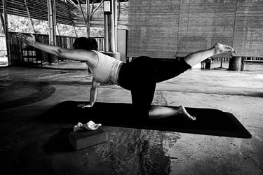 a woman practising Balancing Table  yoga poses on a mat