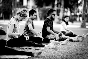 A group of people practising outdoor yoga.