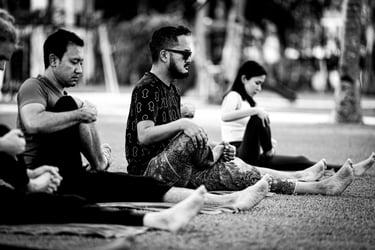 A group of people practising outdoor yoga.