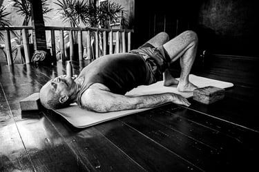 A man practices yoga for Spine & Hip Strength at Santoshayog residency in Siem Reap