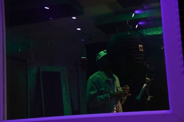 Artist recording in a booth at Troit Ent. Studios