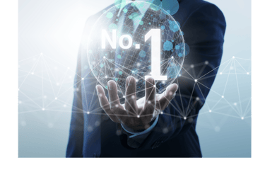 a man in a suit and tie is holding a no 1 sign