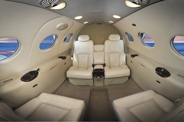 Luxury private jet interior with plush leather seating and panoramic windows, offering premium comfort for VIP travelers and 