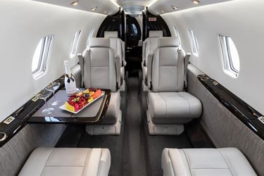 Luxury private jet interior featuring plush leather seats, premium in-flight dining, and VIP comfort. Ideal for business exec