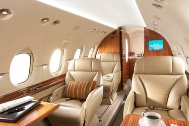 Elegant private jet interior with plush leather seating, wood finishes, and VIP amenities. Ideal for executive travel, busine