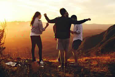a group of people standing on a hill top