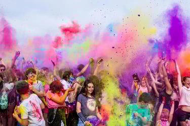 a group of people standing around a group of people with colored powder powder powder powder