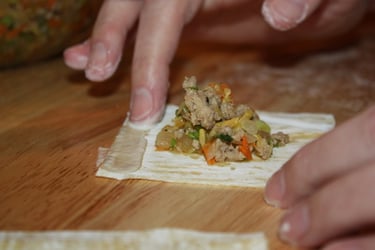 using flour and water to seal the edges of the wonton wrapper