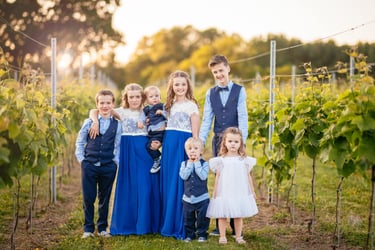 A group photo of child wedding guests ay sunset at llanerch vineyard