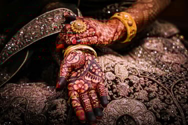 a woman's hands with hennaaches and jewelry
