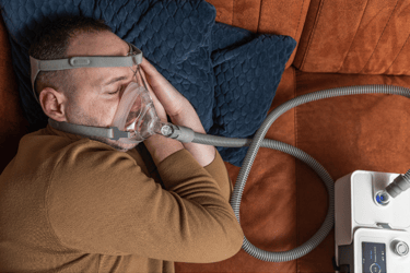 man wearing CPAP machine while sleeping