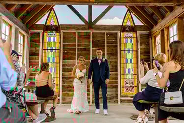 a bride and groom walking down the aisle of a church