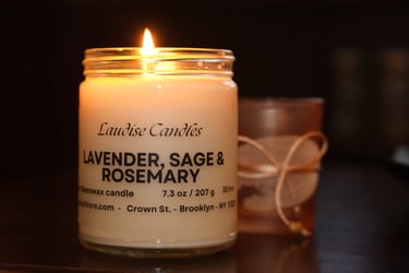 A lit candle. Lavender, Sage and Rosemary - 9oz jar