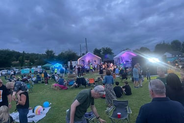Parting in an outside festival field at Woolmer Green