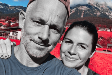 a man and woman taking a selfie in a red - hued photo